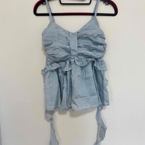 Light blue ruffly camisole with excess fabric drape